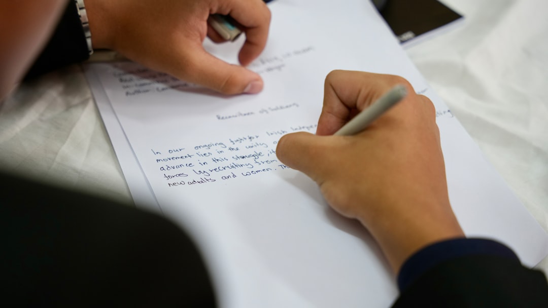 Person writing with a pen — representing the self-study narrative writing process