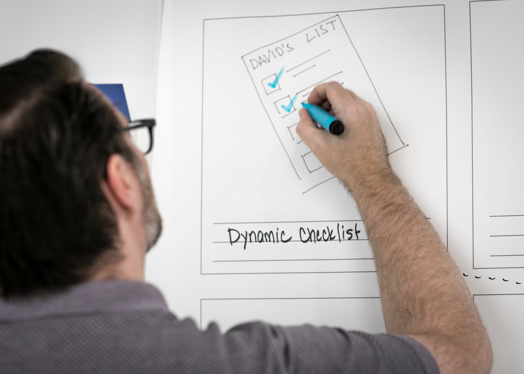 Person writing on whiteboard sketching ideas