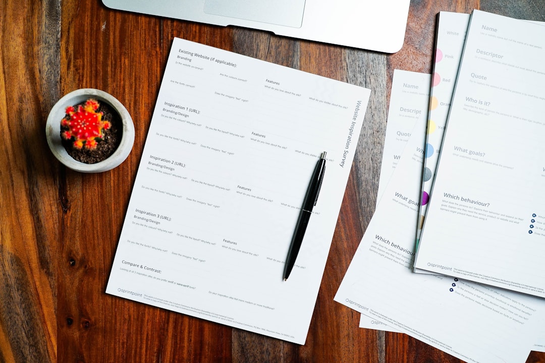 Wooden table with papers and pen — representing the visit preparation documents and organization