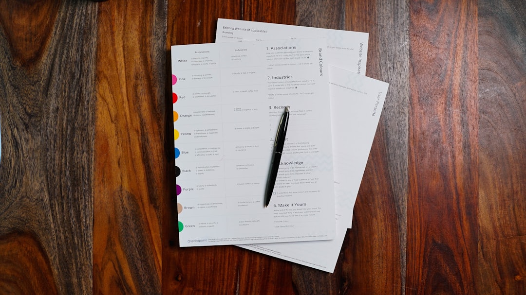 Stack of papers on wooden table — representing the evidence documents that must meet quality standards