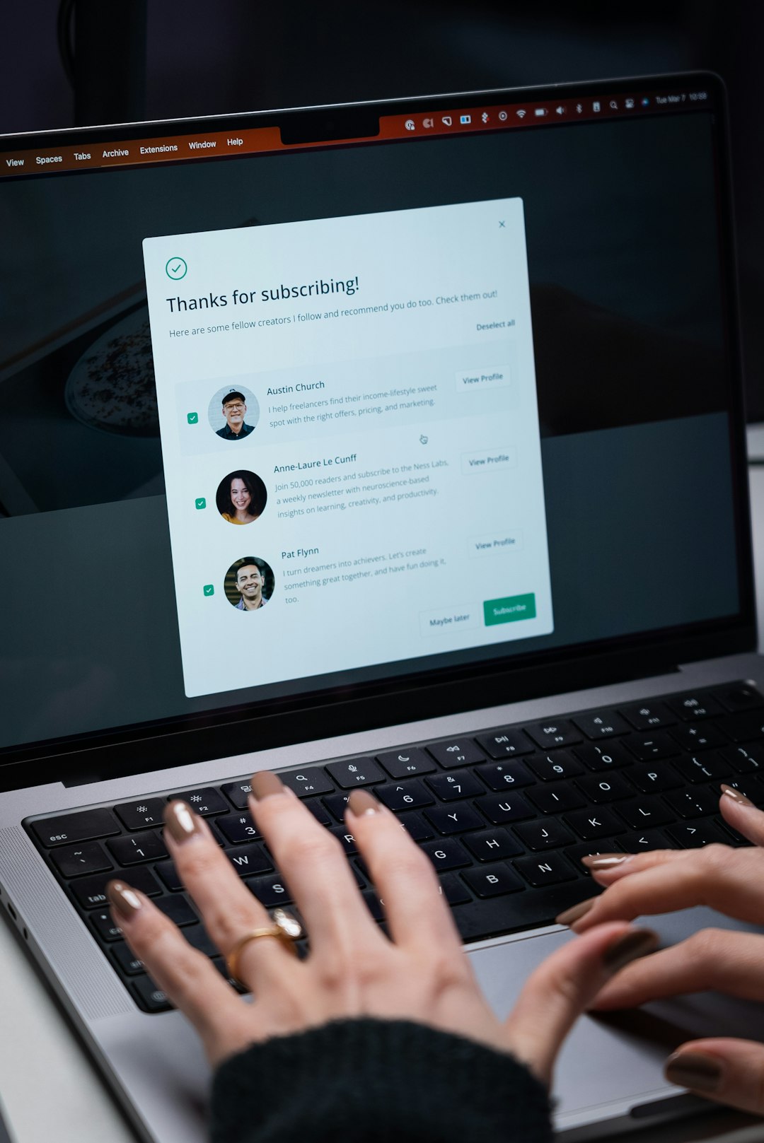 Person typing on a laptop — representing the communication and coordination needed to get faculty to submit evidence