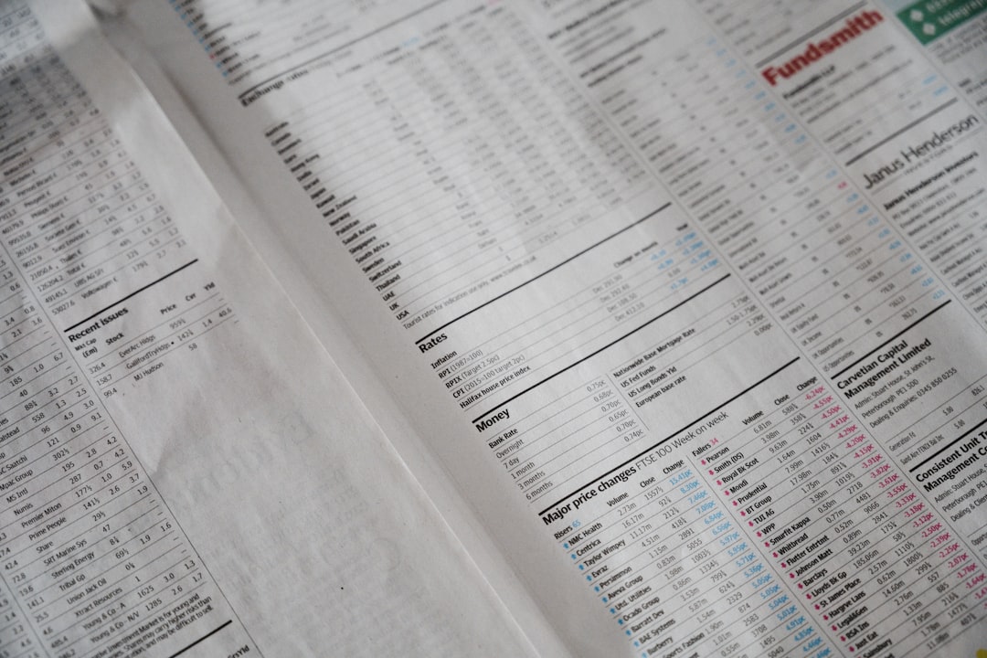 Newspaper finance section with numbers — representing the hidden costs of spreadsheet-based accreditation
