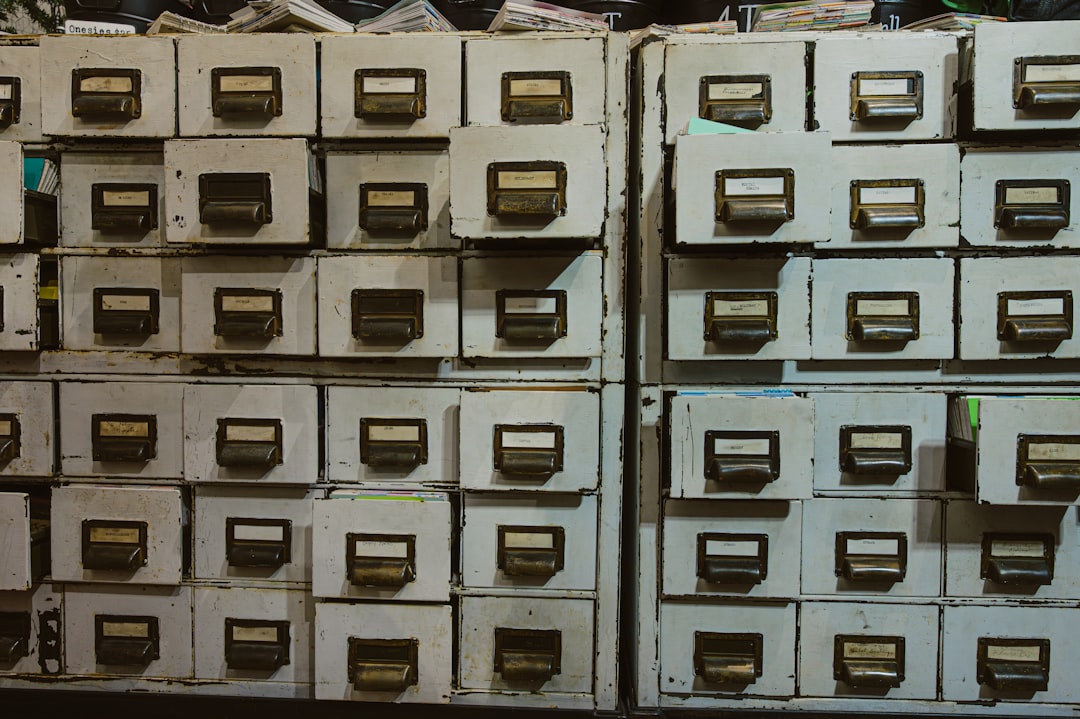 Rows of labeled filing cabinets in an office