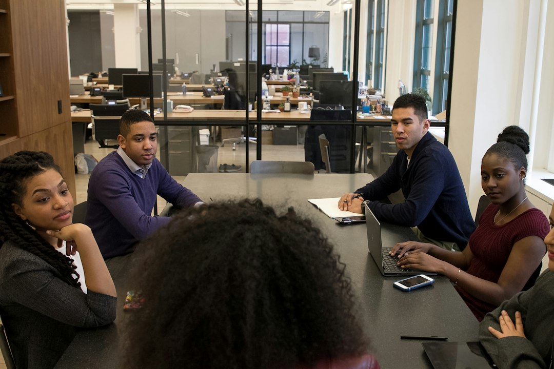Faculty and visiting team members in a focused small-group working session