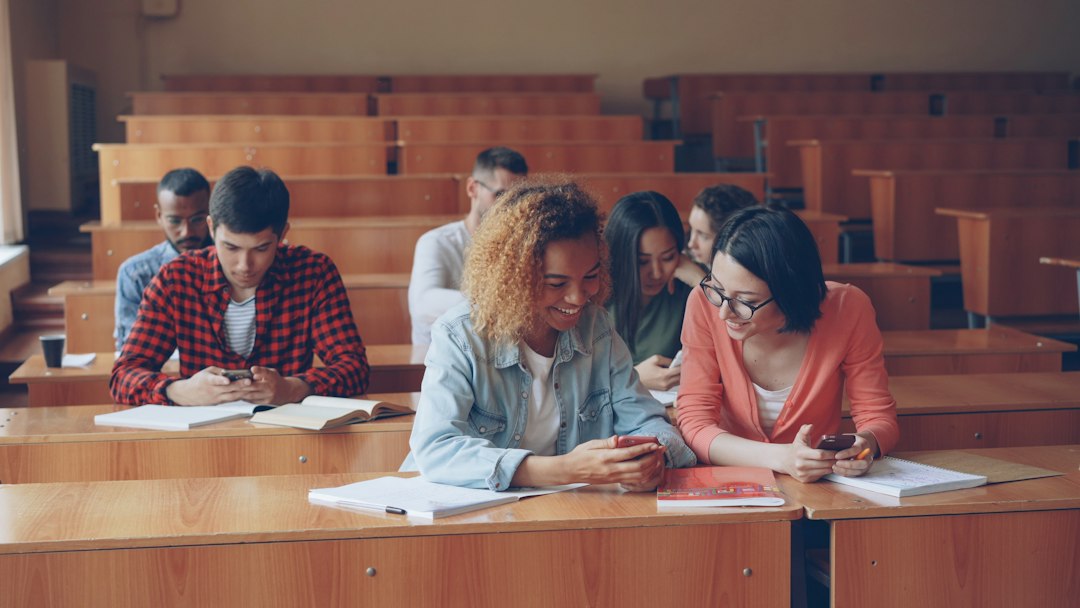 A multiethnic group of university students in a lecture hall, the kind of international student body that dual accreditation helps recruit