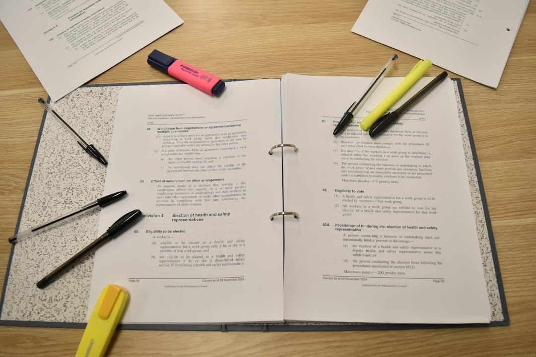 Papers, pens and highlighters laid out on a desk for review, representing the documents a visiting team will look through in a course file