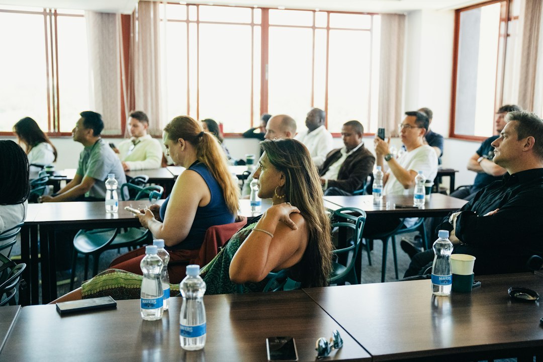 A faculty meeting in a conference room, where evidence submission expectations are set with the team
