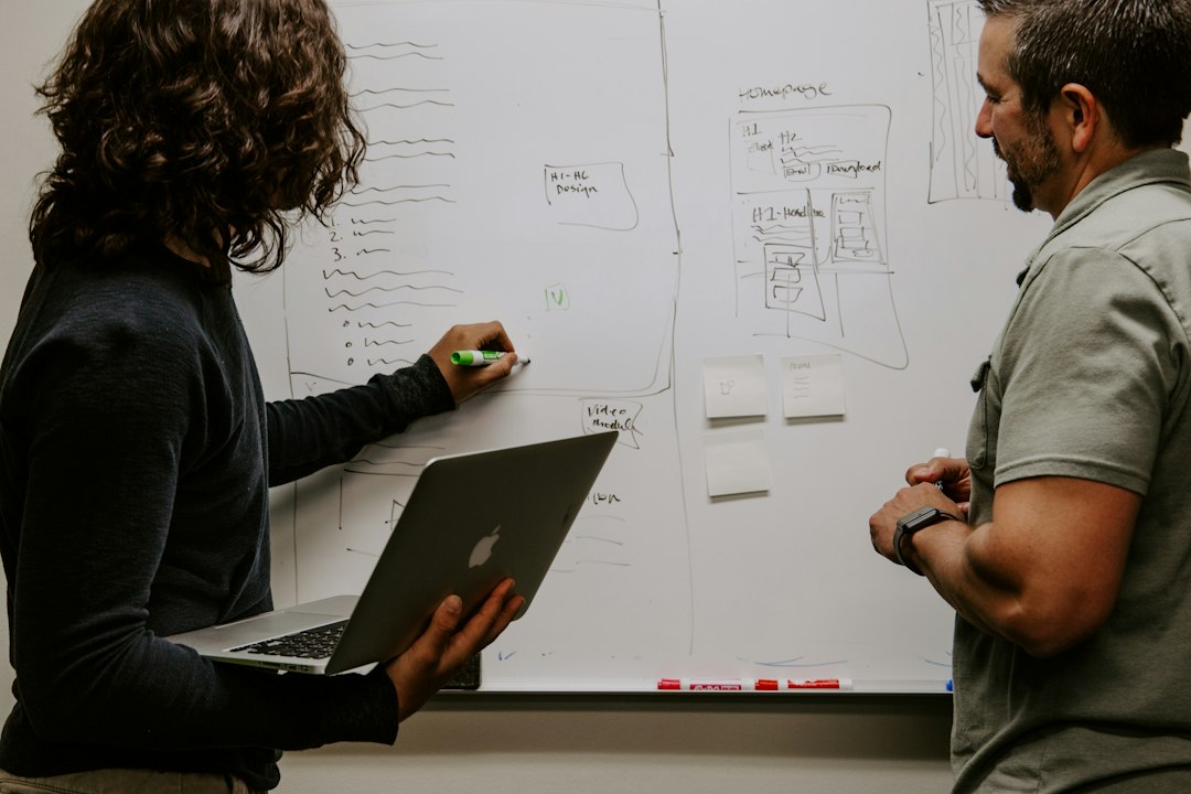Two faculty members re-mapping a curriculum structure at a whiteboard