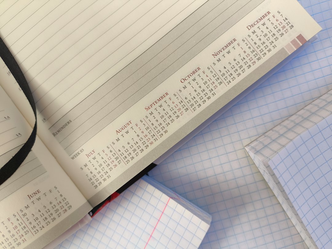 An open planner showing a grid of calendar months, the master view a coordinator uses to track every program's cycle position