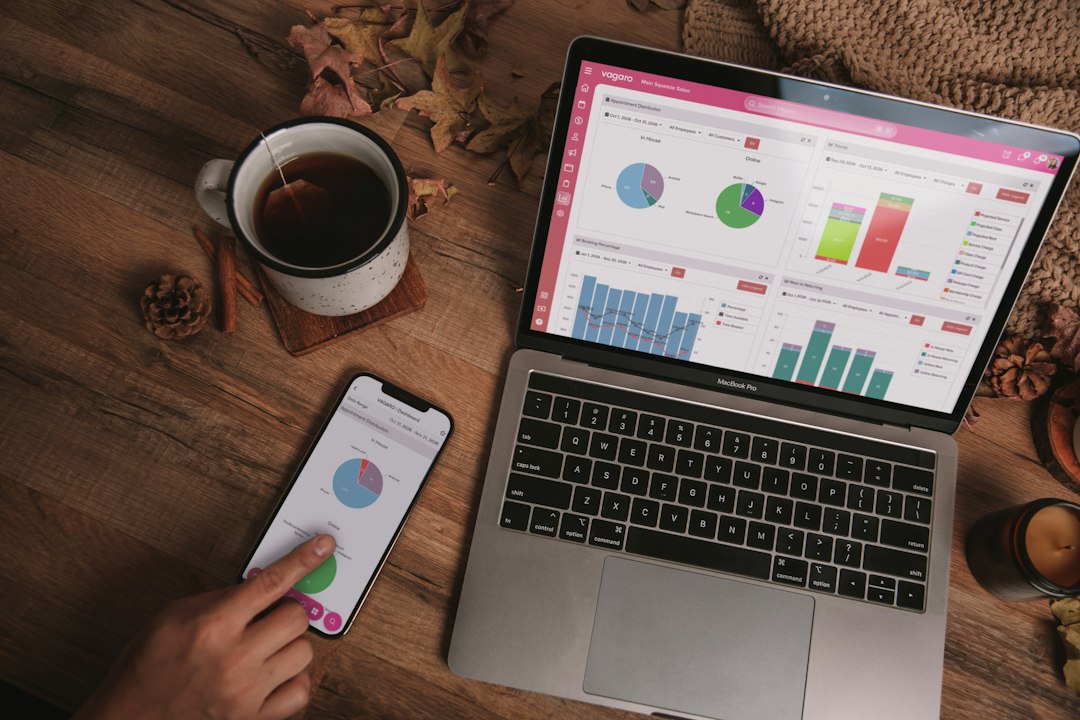 Laptop and phone showing analytics dashboards on a desk — comparing tools before choosing