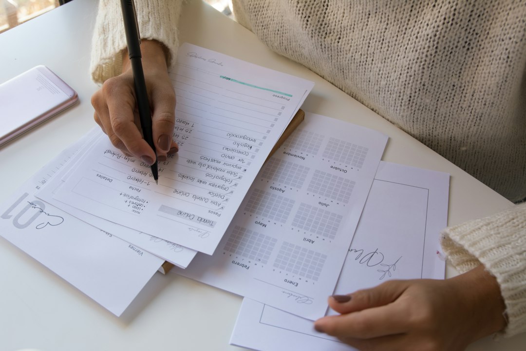 A coordinator filling out accreditation forms, representing the evidence categories Tandem requires