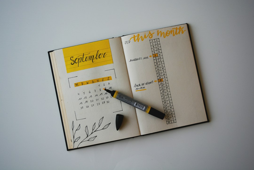 An open monthly planner with a marker, tracking the final stretch of preparation