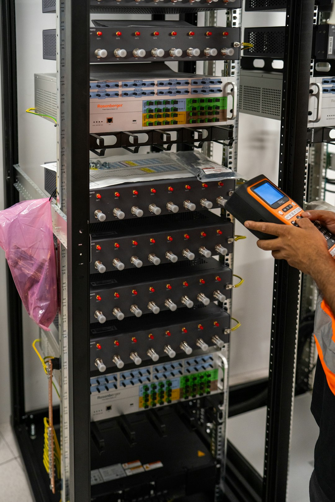 A technician inspecting network equipment in a server rack, representing the safeguards PIPEDA requires