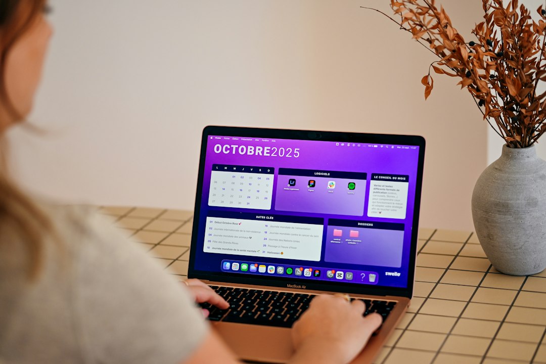 A person viewing a monthly calendar on a laptop, planning the annual maintenance routine for the curriculum map