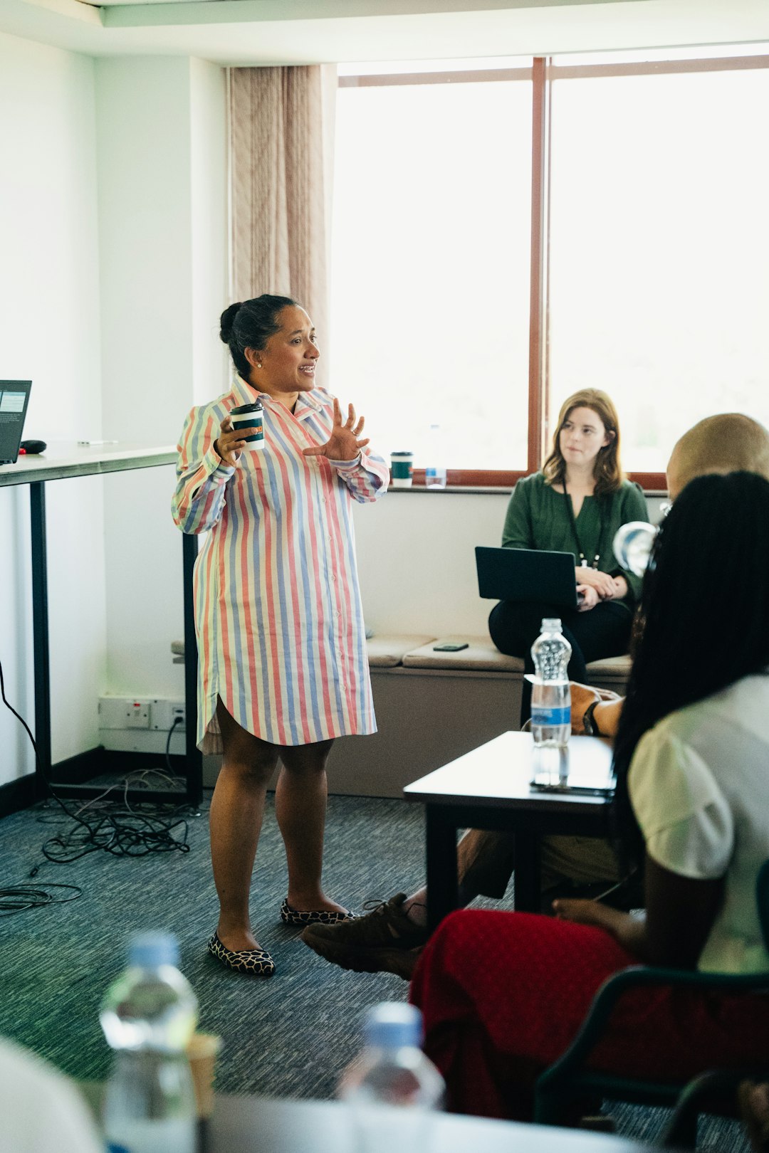 A coordinator presenting the consultation findings to a room of faculty