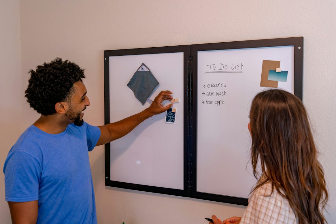 Two faculty members working through an alignment checklist together at a whiteboard