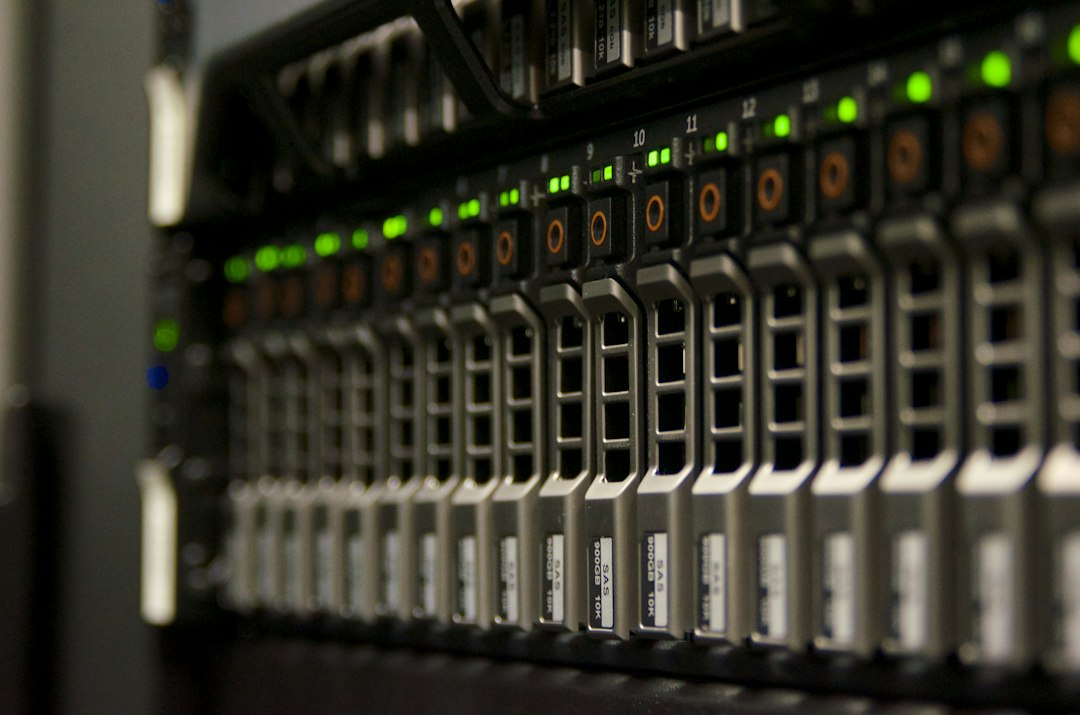 A close-up of a server rack with rows of blinking green status lights in a data center