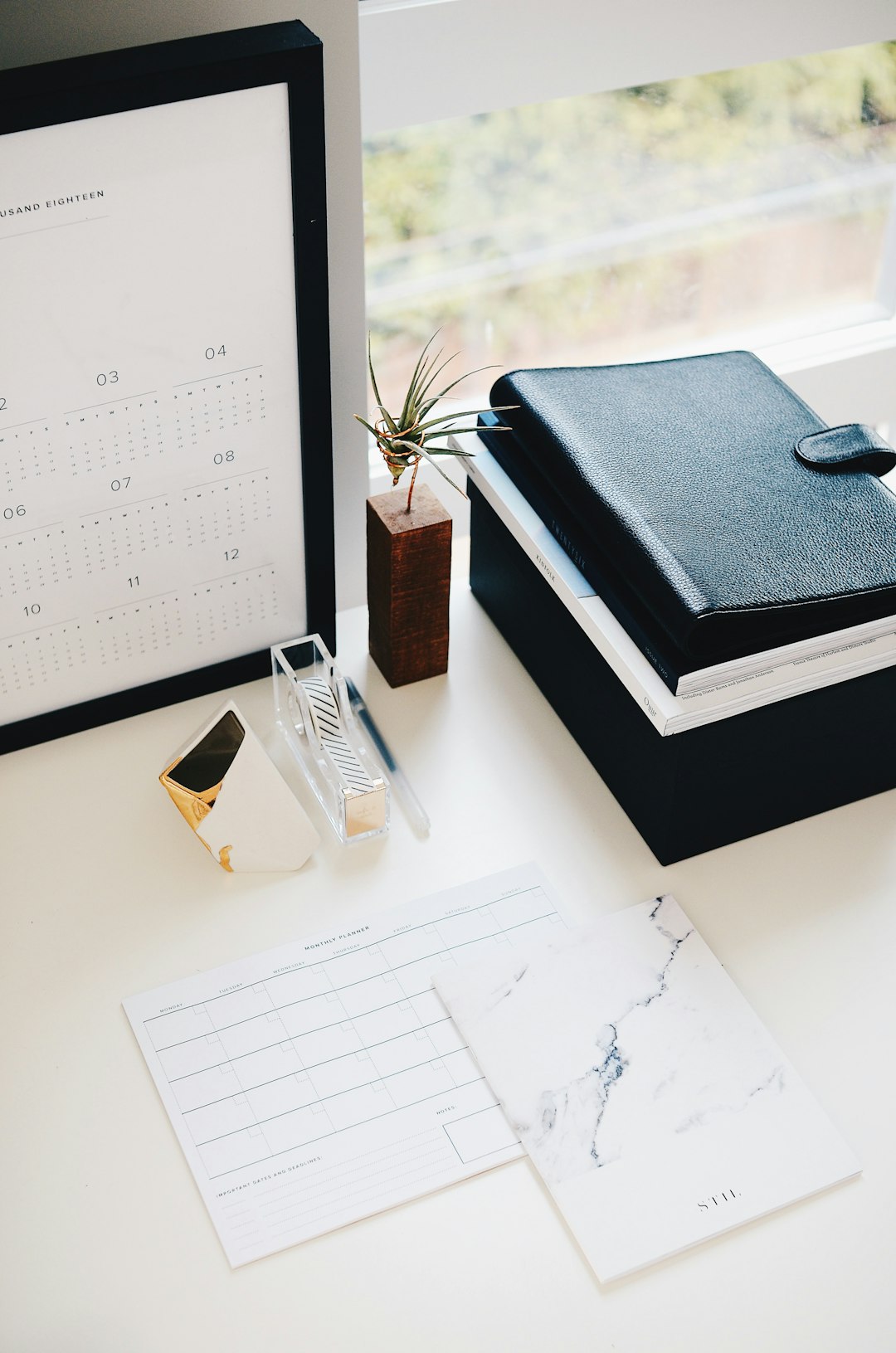 Framed calendar and notebook on a desk planning the accreditation schedule