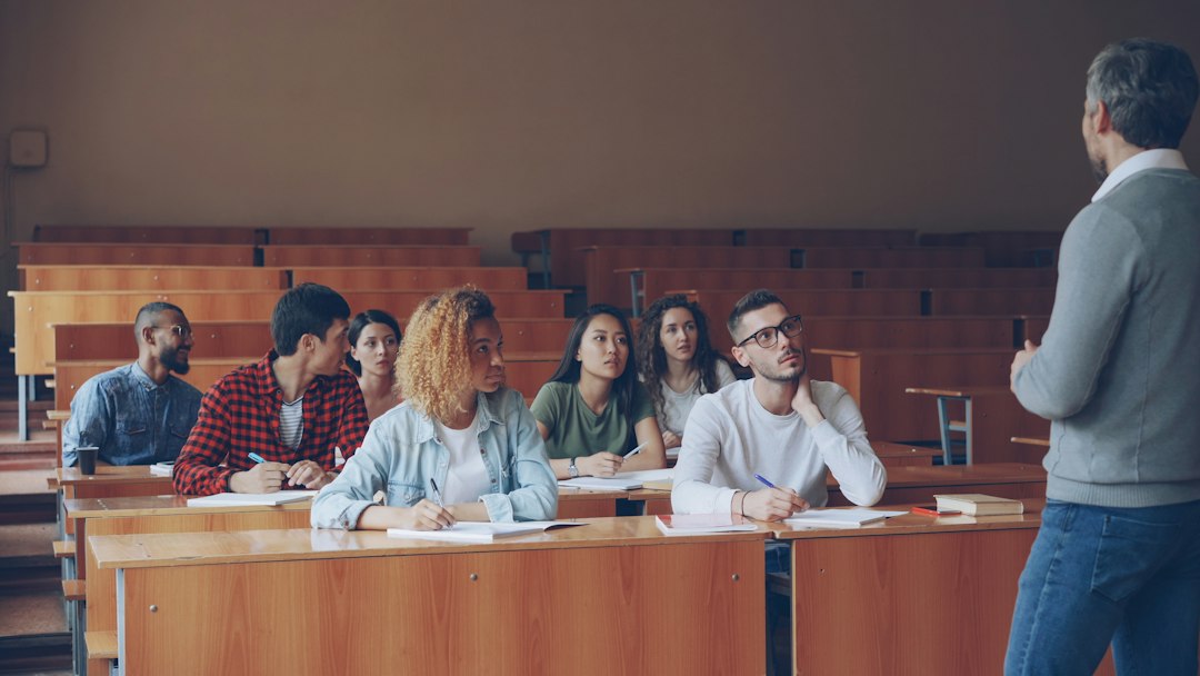 Professor engaging with students in a lecture hall