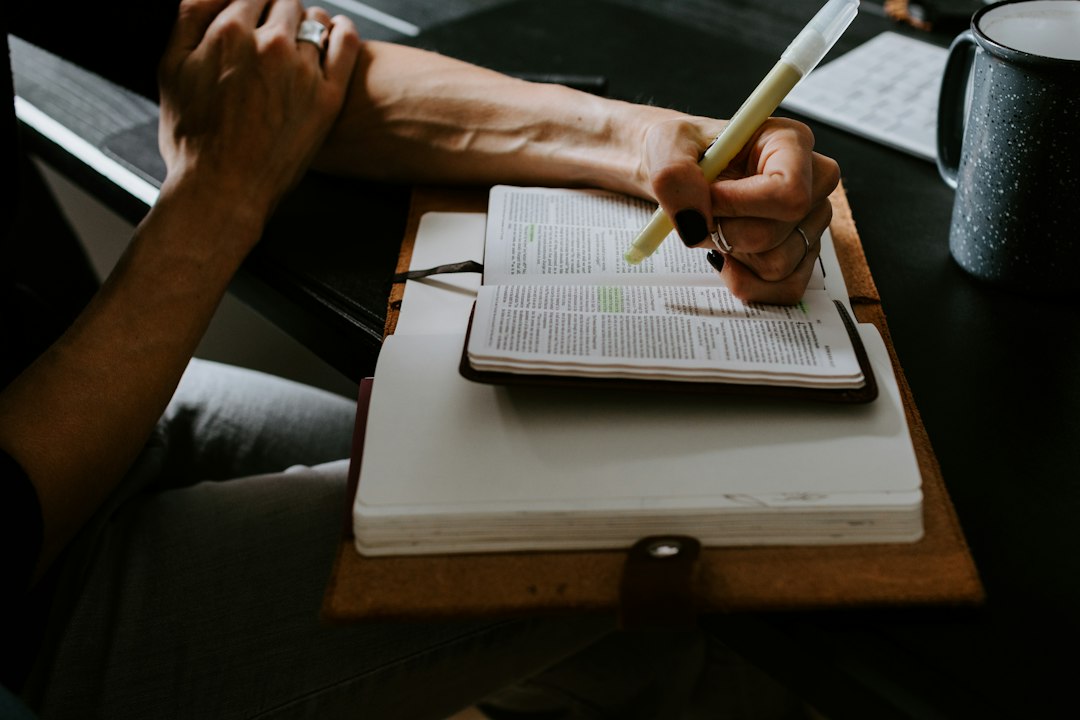 A coordinator writing notes in a notebook while preparing evidence