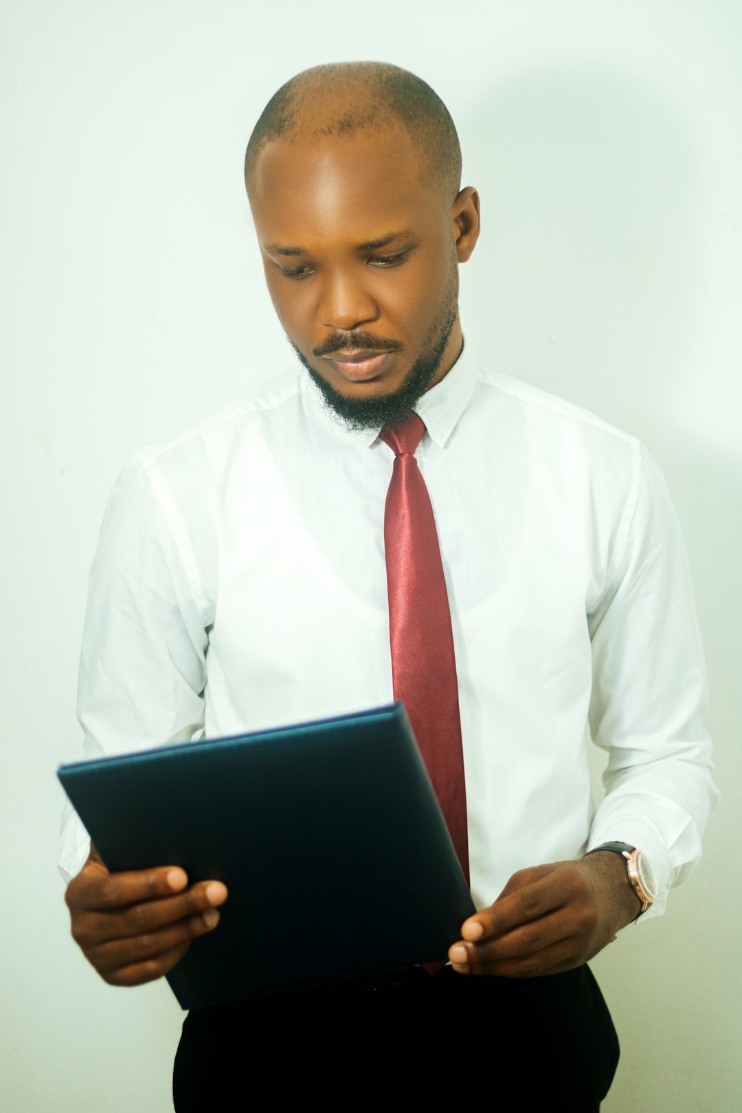 An executive reviewing a report on a tablet, the moment a dean encounters accreditation documentation and judges it on readability