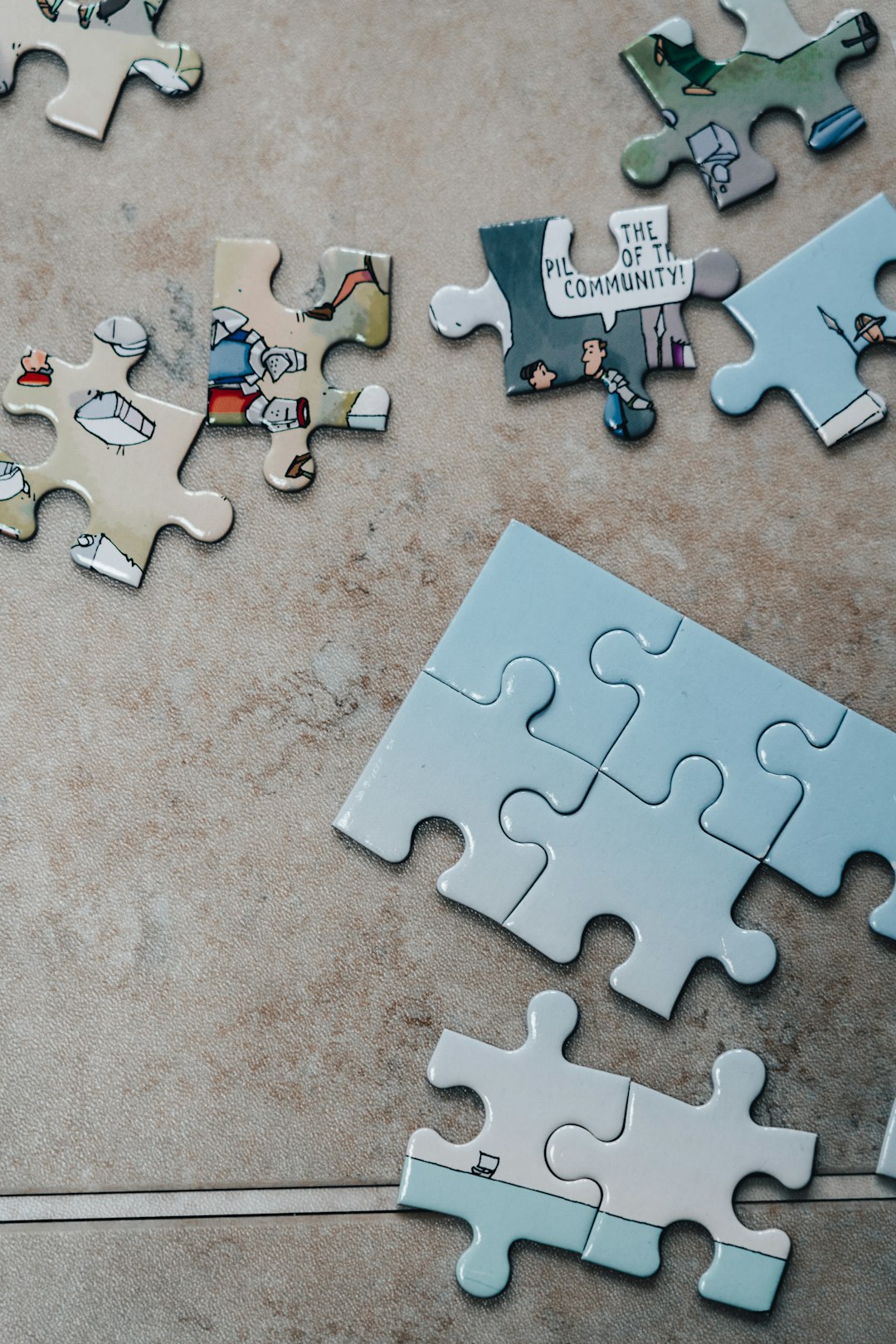 Jigsaw puzzle pieces scattered in separate, unconnected groups